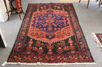 Lot 1119 - A Hamadan Rug, the serreted panel field with...