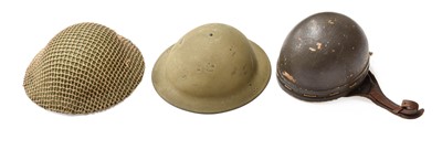 Lot 2220 - Two Second World War Brodie Combat Helmets,...