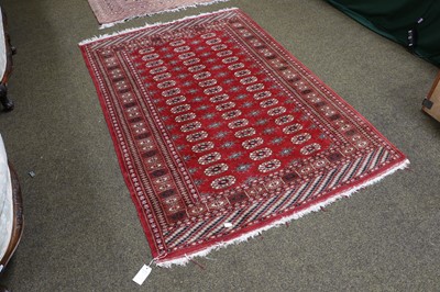 Lot 1110 - A Lahore Bukhara Rug, the claret field with...