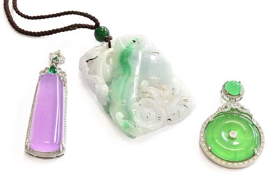 Lot 184 - Three Jade Type Pendants, of varying designs...