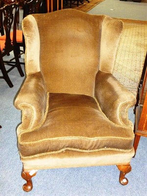 Lot 1272 - A Late Victorian Wing Back Chair, late 19th/early 20th century, recovered in brown velvet, with...