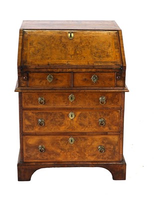 Lot 514 - An Walnut and Feather-Banded Bureau, in George...