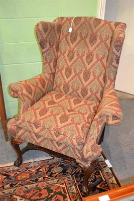 Lot 1275 - A Mahogany Framed Wing Back Chair, probably late 18th century, in George II style, recovered in...