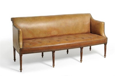 Lot 1277 - A George IV Settee, circa 1830, upholstered in brown close-nailed leather, raised on ring...