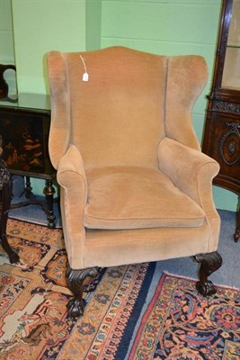 Lot 1279 - A Victorian Wing Back Armchair, late 19th century, upholstered in faded brown velvet, with...