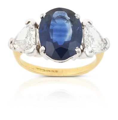 Lot 2310 - An 18 Carat Gold Sapphire and Diamond Three Stone Ring