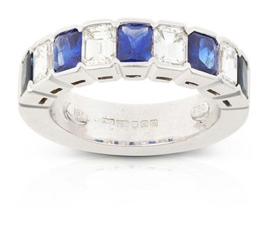 Lot 2312 - An 18 Carat White Gold Sapphire and Diamond Half Hoop Ring