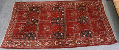 Lot 1089 - An Afghan Prayer Rug, the brick red multi...