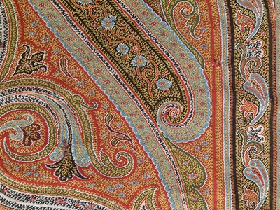 Lot 2133 - Circa 1870 Large Woven Paisley Shawl, on a red...