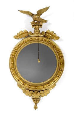 Lot 1289 - A Regency Style Gilt Gesso Convex Wall Mirror, late 19th century, with guilloche and ball...