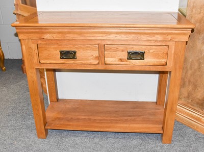 Lot 1137 - A Modern Oak Two Drawer Side Table, raised on...