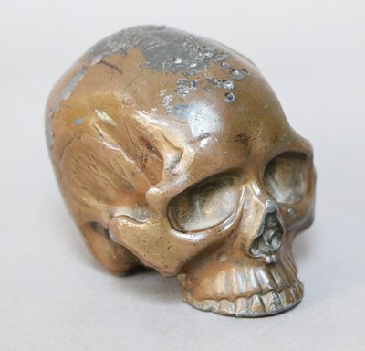 Lot 321 - A Small Bronzed Lead Skull, 20th century, 5cm