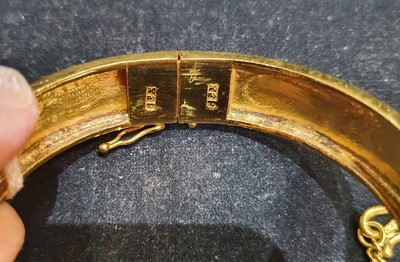 Lot 2286 - A Pair of Hinged Bangles engraved to depict...