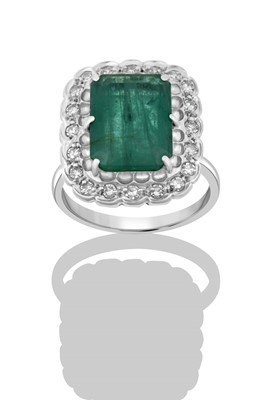 Lot 2281 - An Emerald and Diamond Cluster Ring, by...