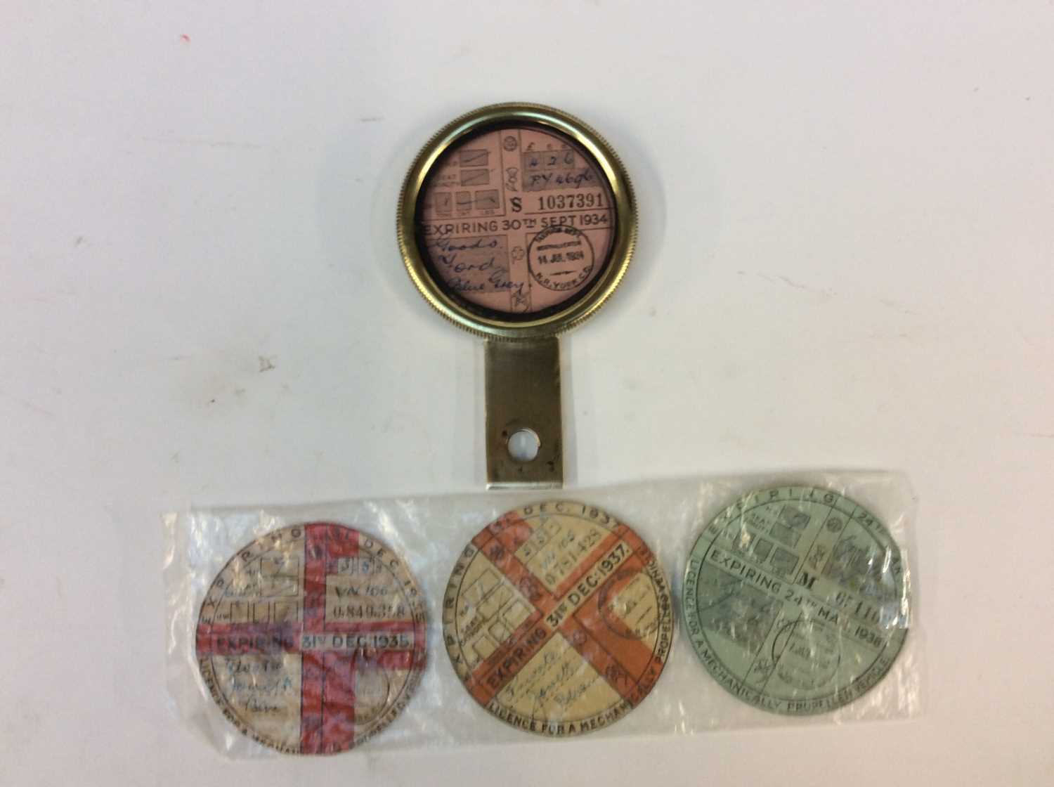 Lot 91 - A 1930's Brass Tax Disc Holder, containing a...