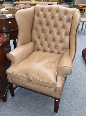 Lot 1154 - A Reproduction Leather Wing Back Armchair, in...