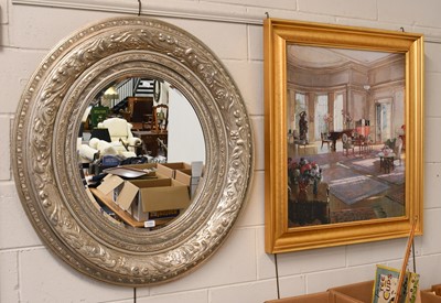 Lot 1150 - A Large Oval Wall Mirror in an Ornate Silvered...