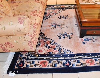 Lot 1227 - A Chinese Carpet, the candy pink field centred...