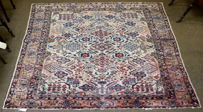 Lot 1202 - A Tabriz Carpet, the ivory field of angular...