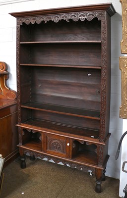 Lot 1448 - An Anglo-Indian Carved Hardwood Open Bookcase,...