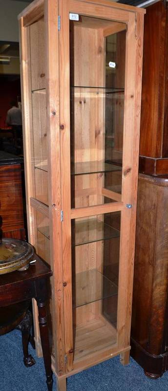 Lot 812 - A glazed pine display cabinet