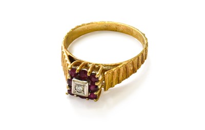 Lot 1 - An 18 Carat Gold Ruby and Diamond Cluster Ring,...