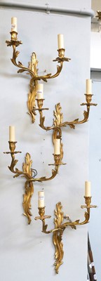 Lot 1117 - A Set of Four Gilt Metal Twin Light Wall...