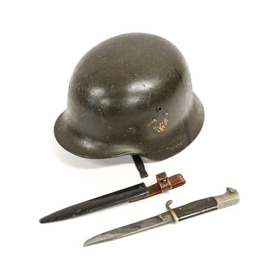 Lot 123 - A Second World War Geman M35 Combat Helmet,...