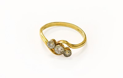 Lot 104 - A Diamond Three Stone Twist Ring, stamped...