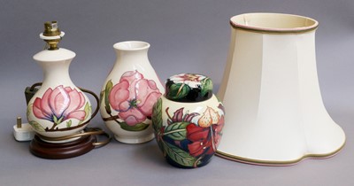 Lot 270 - Moorcroft Comprising: a magnolia lamp and vase...