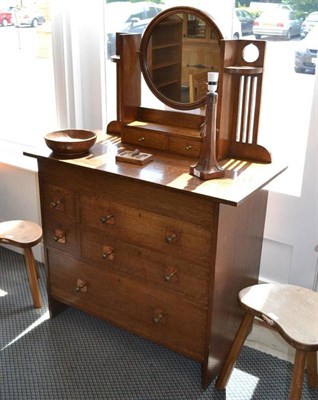 Lot 996A - An Arts & Crafts Oak Dressing Chest, the circular mirror enclosed by slatted supports above two...