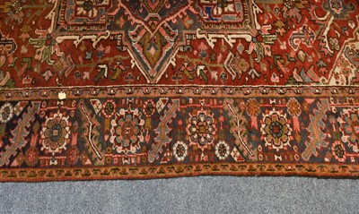 Lot 1216 - A Heriz Carpet, the brick red field with...