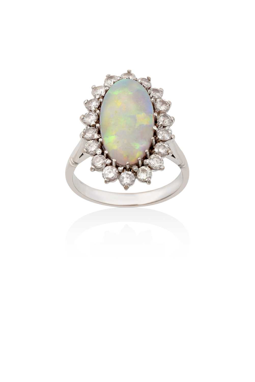 Lot 2145 - An Opal and Diamond Cluster Ring the oval...