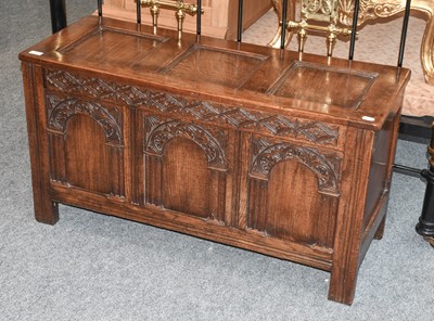 Lot 1141 - An Early 20th Century Carved Oak Three Panel...