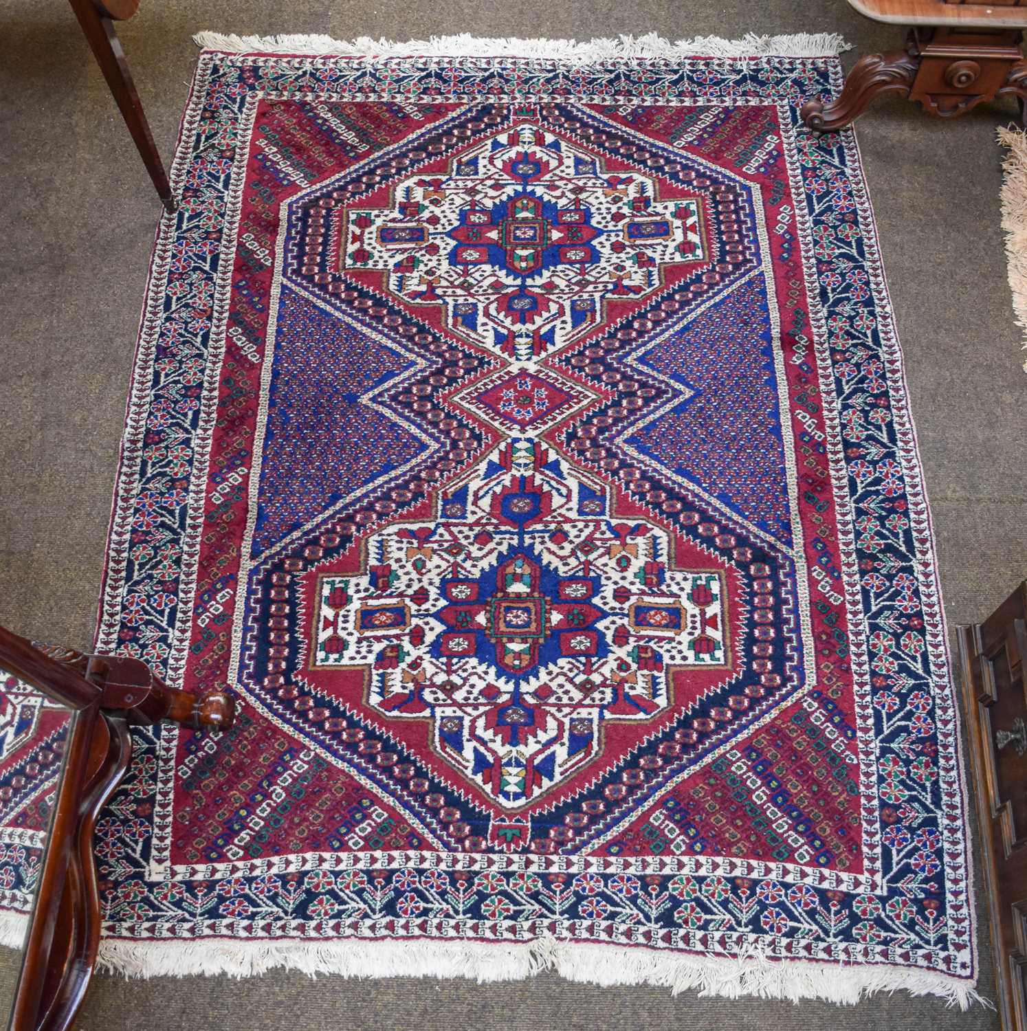 Lot 1204 - A Lesghi Design Rug, the ivory ground with