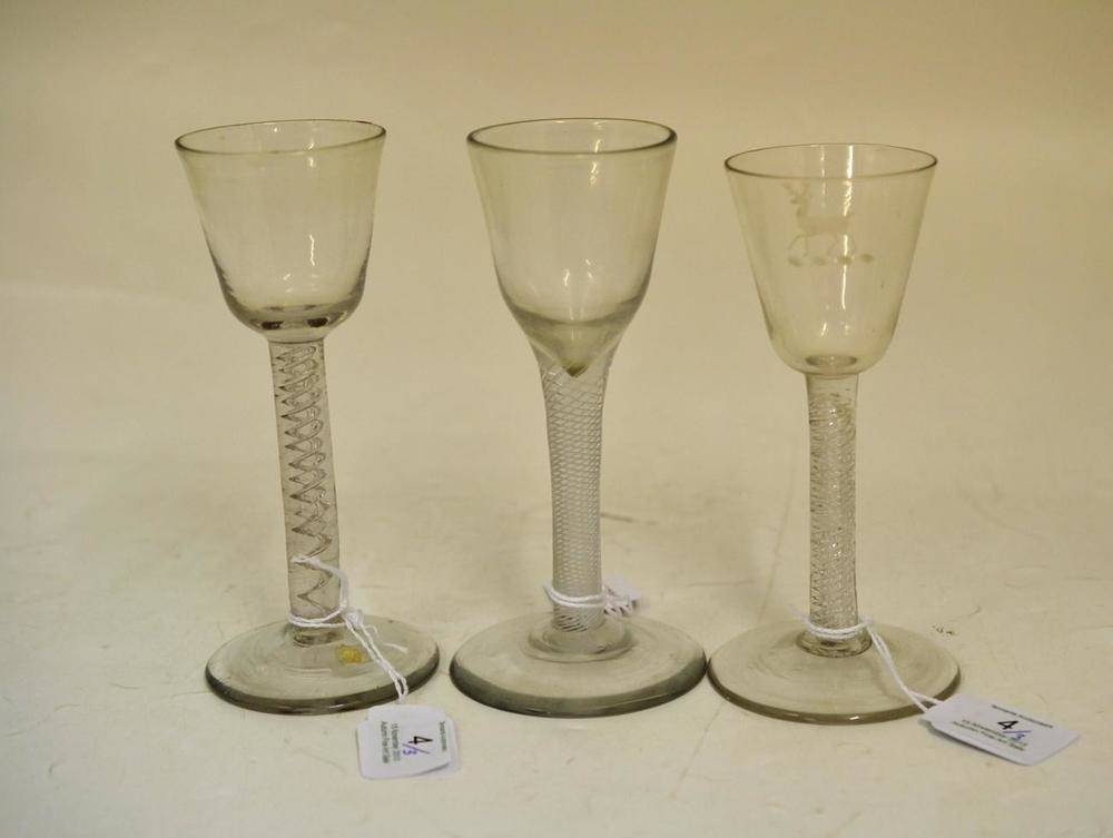 Lot 4 - A Wine Glass, circa 1750, the rounded funnel bowl on an air twist stem and circular foot,...