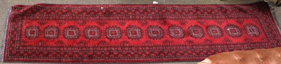 Lot 1223 - Narrow Afghan Runner, the claret field with a...