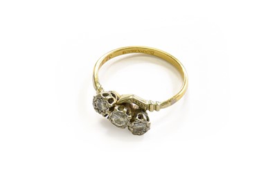 Lot 159 - A Diamond Three Stone Twist Ring, stamped...