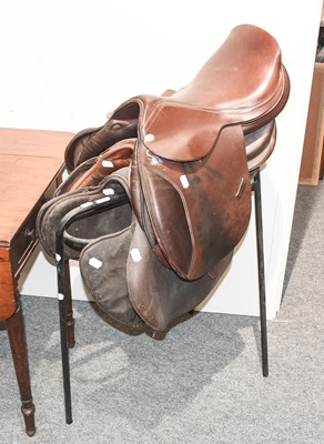 Lot 1179 - Three Leather Saddles and A Metal Saddle Stand