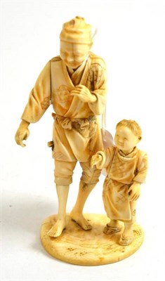 Lot 84 - Ivory okimono of a man and boy