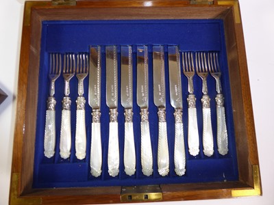 Lot 2055 - A Cased Set of Eighteen Pairs of Victorian Silver and Mother-of-Pearl Fruit-Eaters