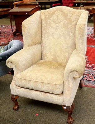 Lot 1384 - A George III Style Wingback Chair, raised on...