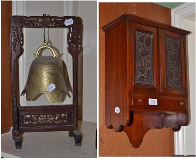 Lot 103 - An Edwardian walnut small wall cupboard enclosed by foliate carved panelled doors and a Chinese...