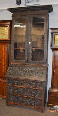 Lot 1337 - A Victorian Ebonised Carved Oak Bureau...