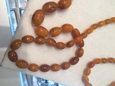 Lot 170 - A Graduated Amber Bead Necklace, length 130cm...