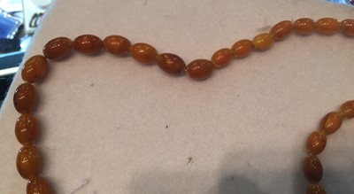 Lot 170 - A Graduated Amber Bead Necklace, length 130cm...
