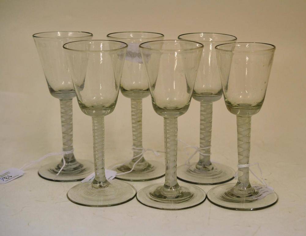 Lot 13 - A Set of Six Wine Glasses, circa 1755, the flared bucket shaped bowls on opaque twist stems,...