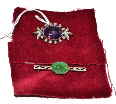 Lot 131 - An amethyst and diamond brooch and a jade and diamond bar brooch (2)