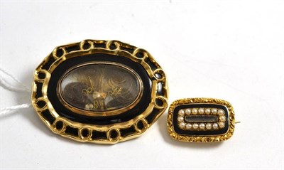 Lot 138 - A black enamelled mourning brooch with locket enclosing three locks of hair, engraved to the...