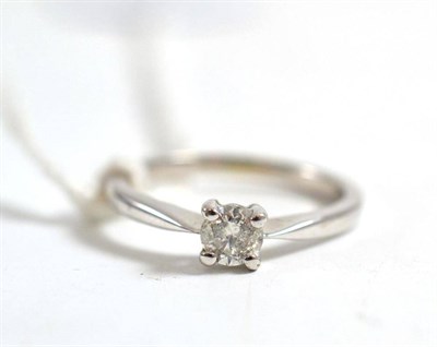 Lot 139 - A diamond solitaire ring, the round brilliant cut diamond in a white four claw setting, to a...